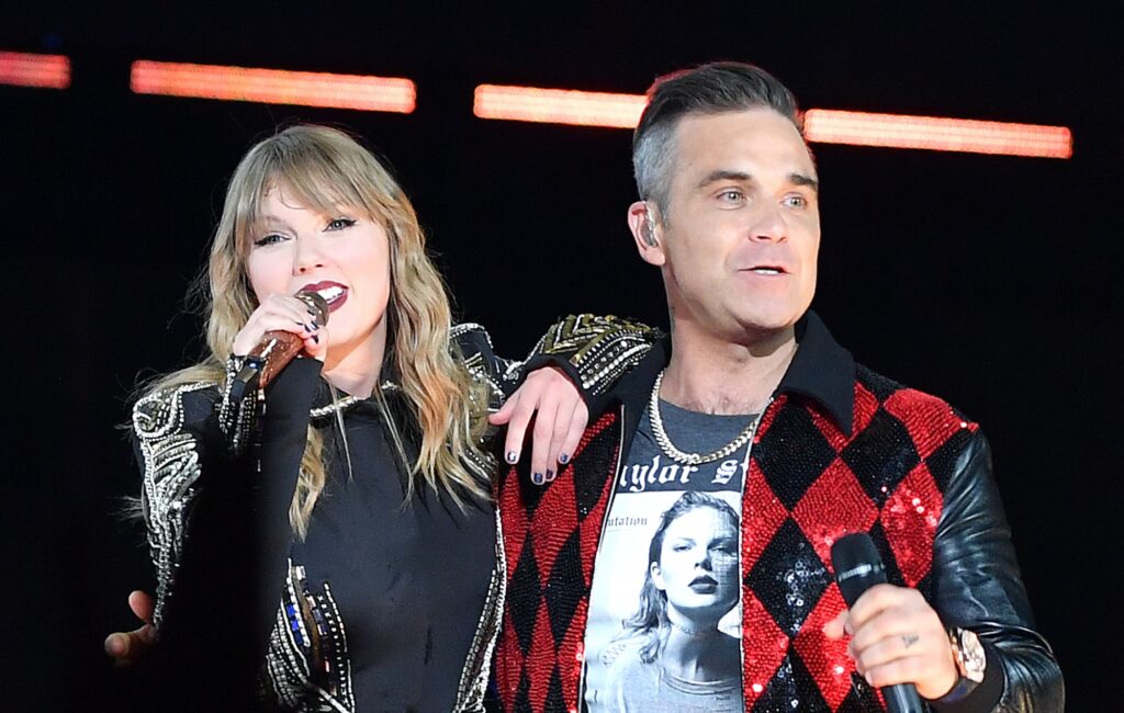 robbie-williams-doesn’t-think-taylor-swift-“knew-anything-about-him”-when-she-invited-him-on-stage